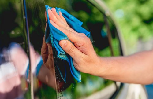 Cleaning car window with rag
