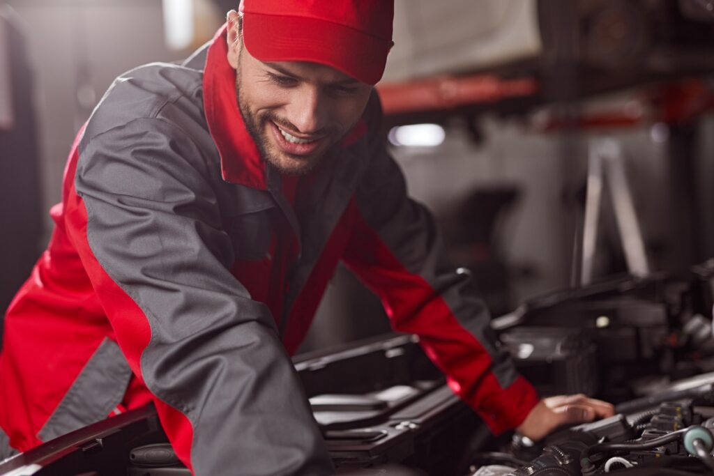 Mechanic repairing engine of car