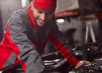 Mechanic repairing engine of car